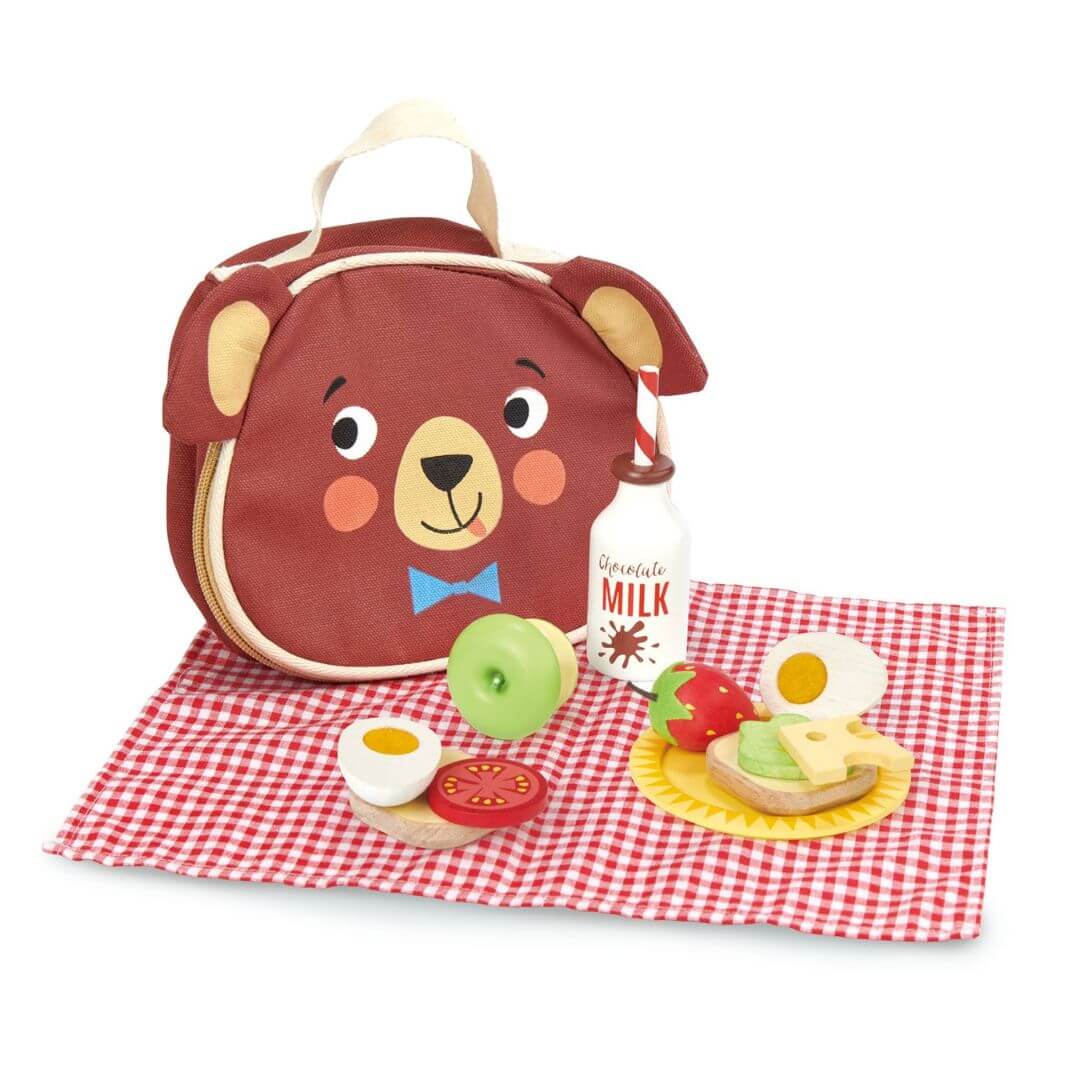 Bear-shaped lunch bag with food items on a red and white checkered cloth. Tender Leaf Toys