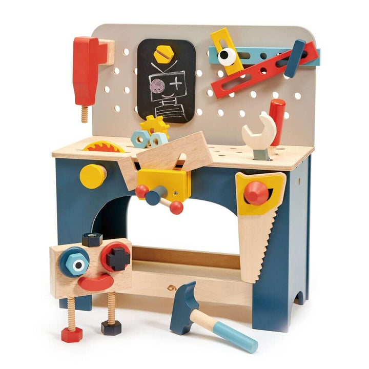 Children's wooden toy workbench with various tools and a chalkboard on a white background. Tender Leaf Toys