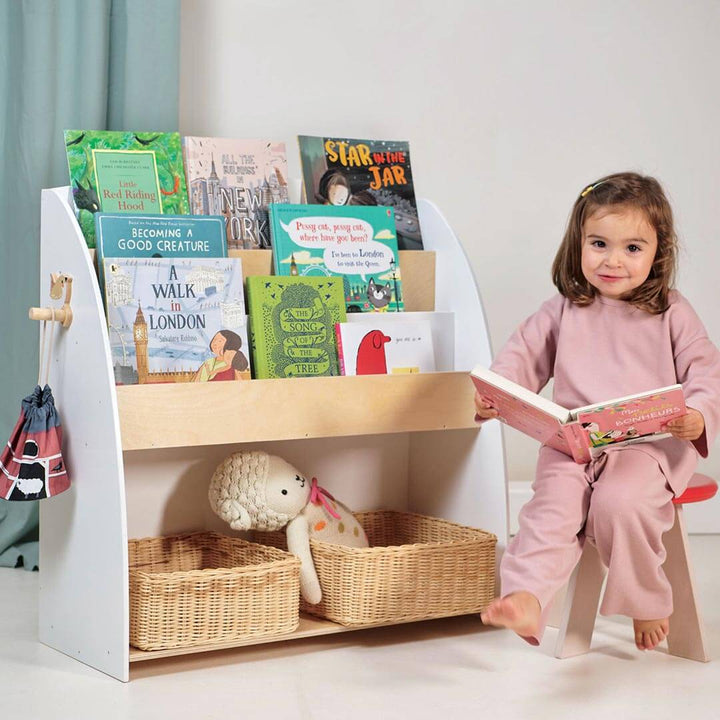 Child reading next to Tender Leaf Toys Forest Collection Wooden Book Shelf and Storage Unit