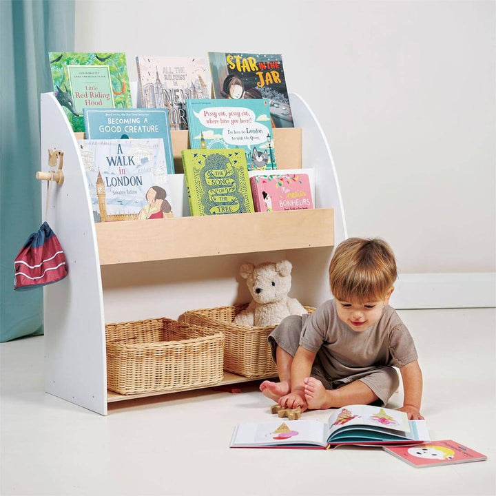 Child reading in front of Tender Leaf Toys Forest Collection Wooden Book Shelf and Storage Unit