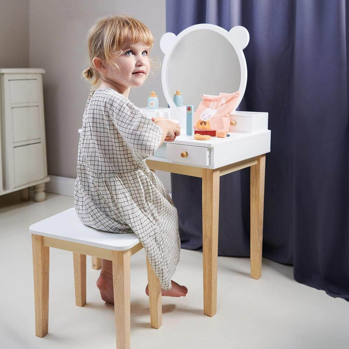 Child sitting at Tender Leaf Toys Forest Collection Wooden Dressing Table and Stool