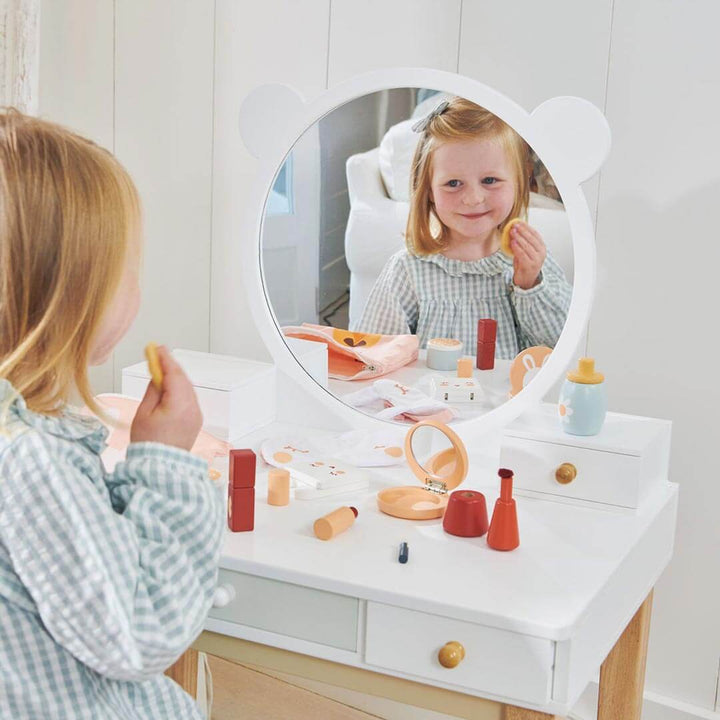 Child in mirror sitting at Tender Leaf Toys Forest Collection Wooden Dressing Table and Stool