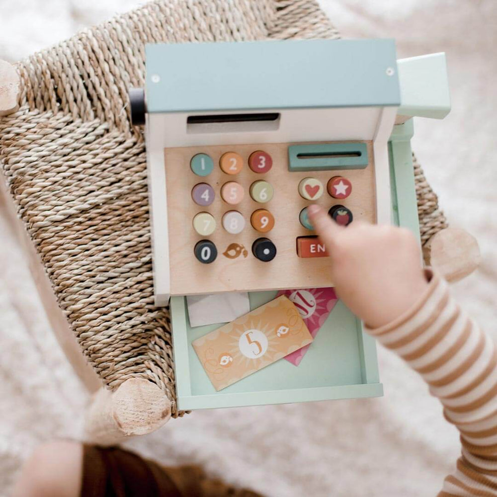 Child playing with Tender Leaf Toys Wooden General Store Cash Register