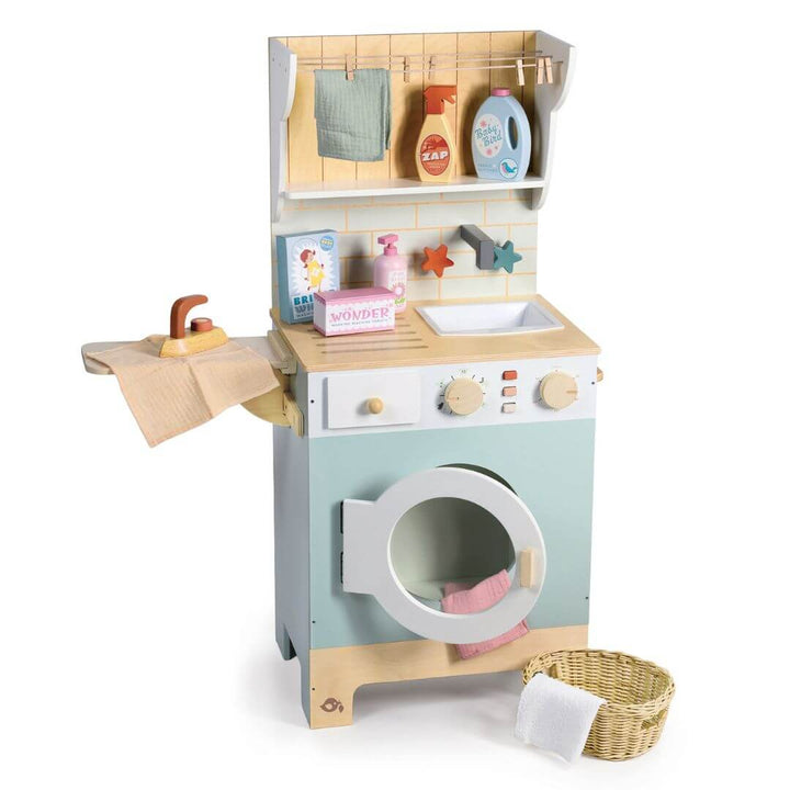 Toy laundry set from Tender Leaf Toys with washing machine, dryer, and various items on a white background