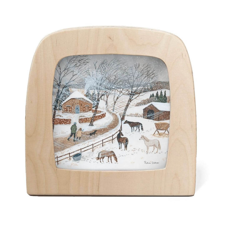 Toverlux Lamp Transparency – “Cold Snap” by Robin Pieterse, from the Winter Collection. A snowy farm scene with horses and a figure tending to animals near a cozy stone cottage - Bella Luna Toys