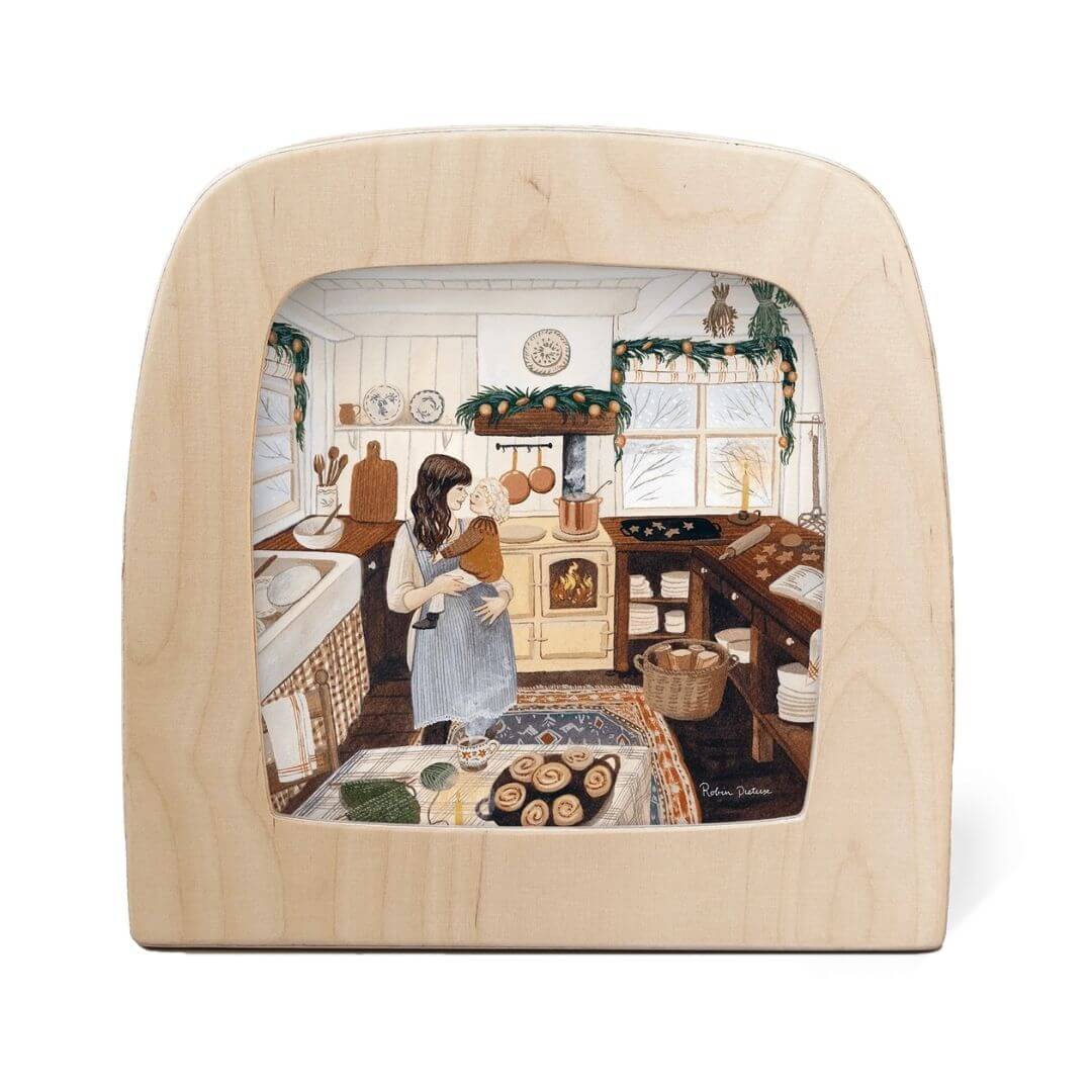 Toverlux Lamp Transparency – “Winter Baking” by Robin Pieterse, from the Winter Collection. A mother and child baking together in a warmly lit kitchen decorated for winter - Bella Luna Toys