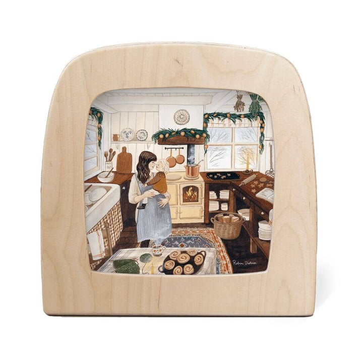 Toverlux Lamp Transparency – “Winter Baking” by Robin Pieterse, from the Winter Collection. A mother and child baking together in a warmly lit kitchen decorated for winter - Bella Luna Toys