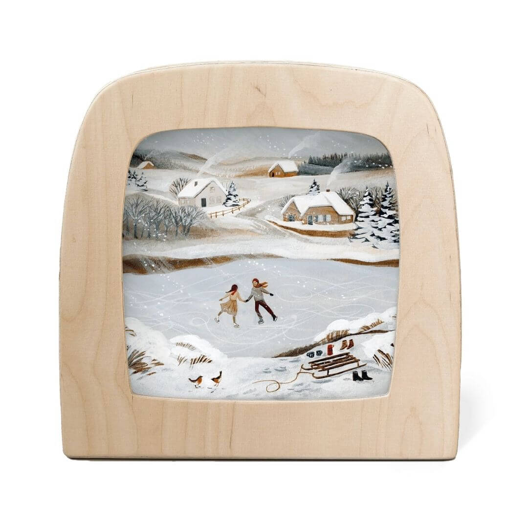Toverlux Lamp Transparency – “Rosy Cheeks” by Robin Pieterse, from the Winter Collection. A snowy village scene with children ice skating and cottages nestled in a frosty landscape - Bella Luna Toys