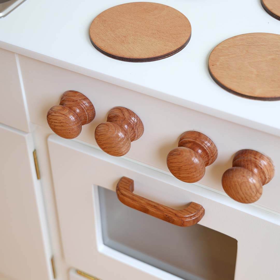 Wooden knobs on a kitchen cabinet and stove