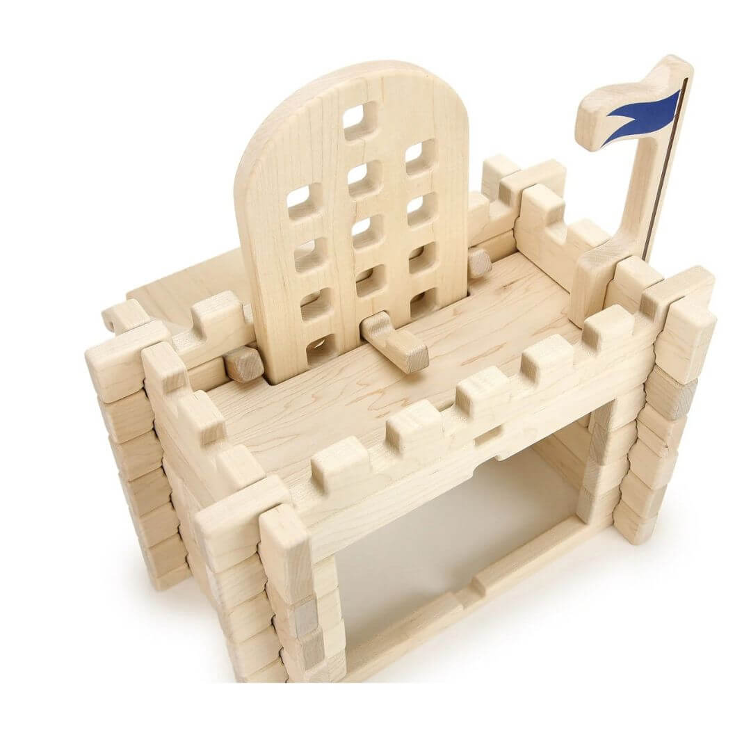 Everwood Friends Wooden Notch Blocks Castle Gate Set assembled into a medieval castle entrance made from natural hard maple wood. The detailed structure features interlocking wooden walls, crenellated battlements, a flag flying above the castle - Bella Luna Toys