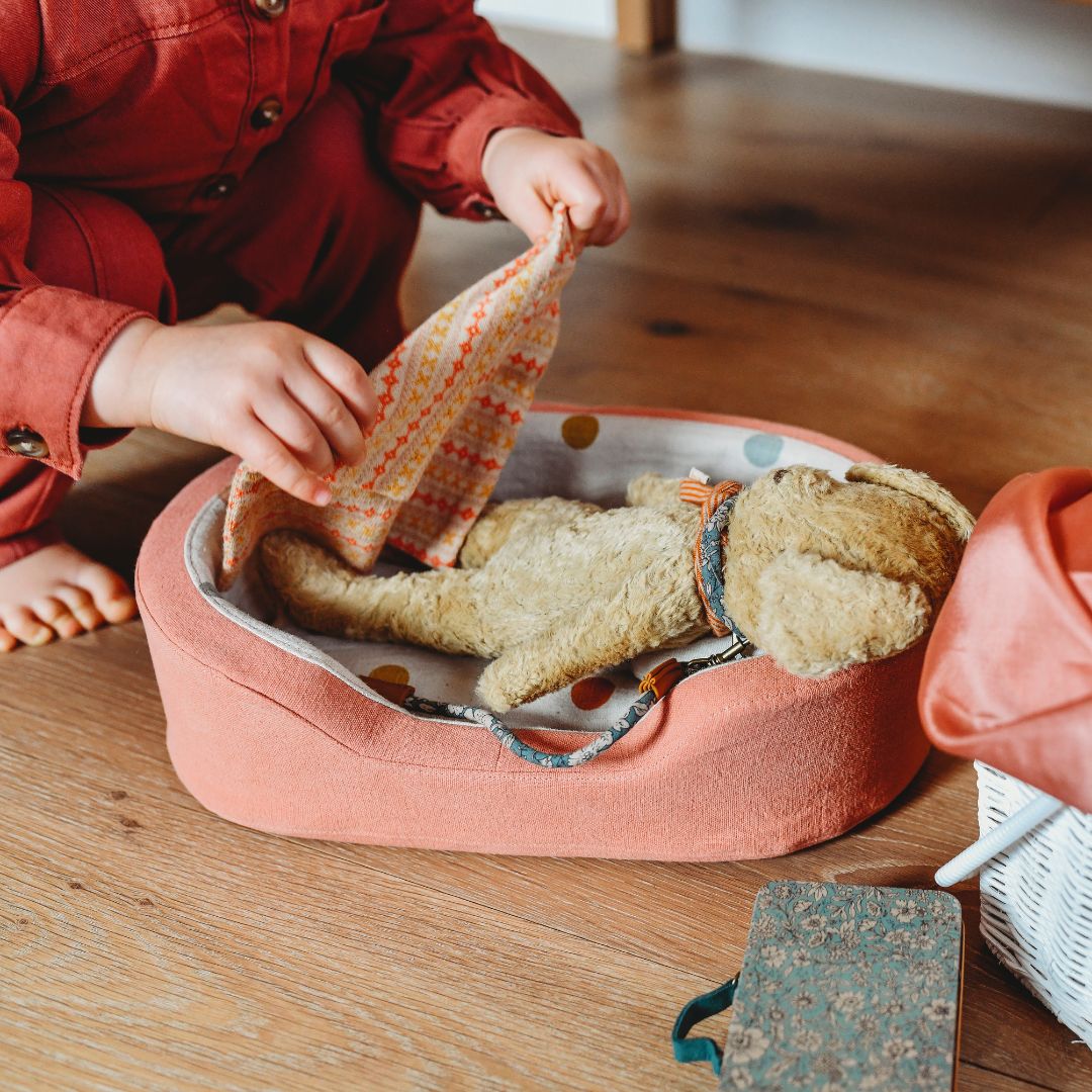 Maileg Plush Dog- Child laying scarf on plush dog in dog bed-Stuffed Animals- Bella Luna Toys