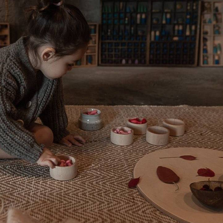Child playing with and sorting Grapat Wooden Mandala Flower Petals