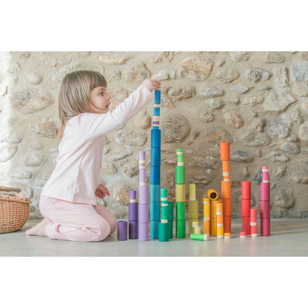 Child stacking and playing with Lola set