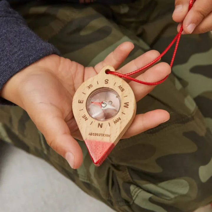 Kikkerland- Wooden Compass-Outdoor Toys- Child holding wooden compass in hand- Bella Luna Toys