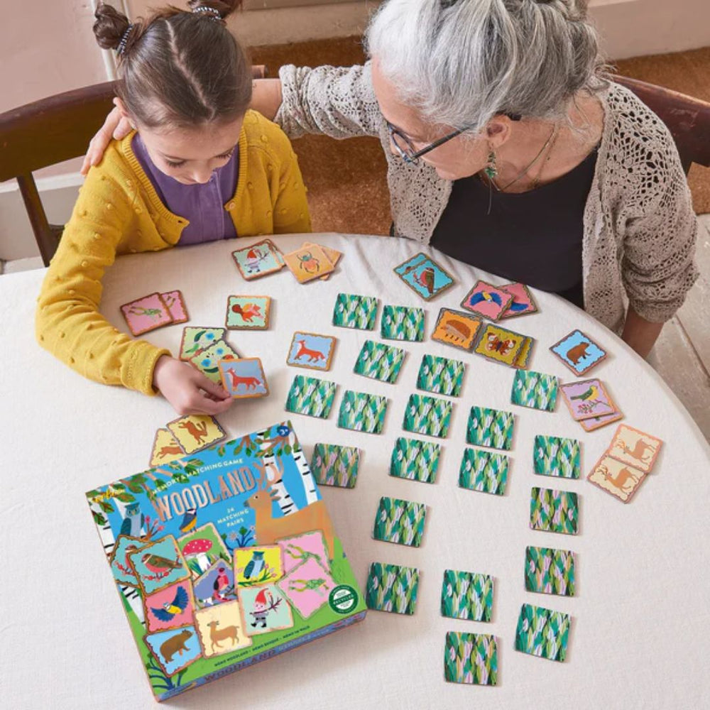 Grandparent and child playing memory card game at table- Bella Luna Toys