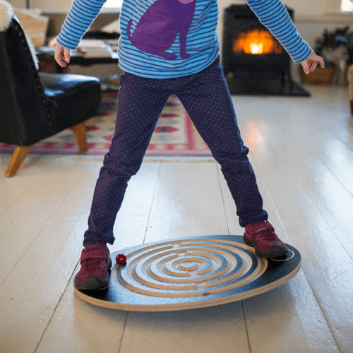 Balancing on Labyrinth Wooden Balance Board