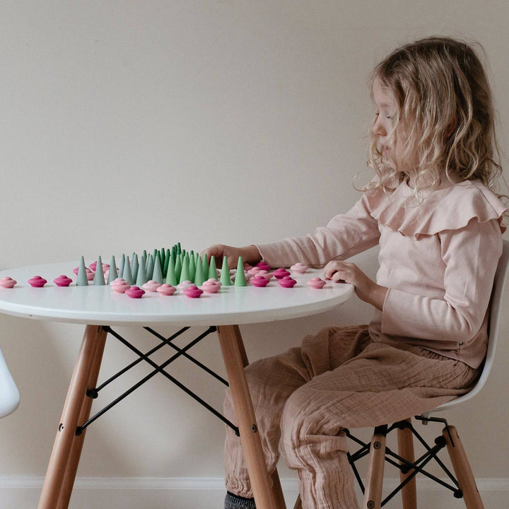 Grapat- Child playing with gradient green mandala cones at white colored table- Bella Luna Toys