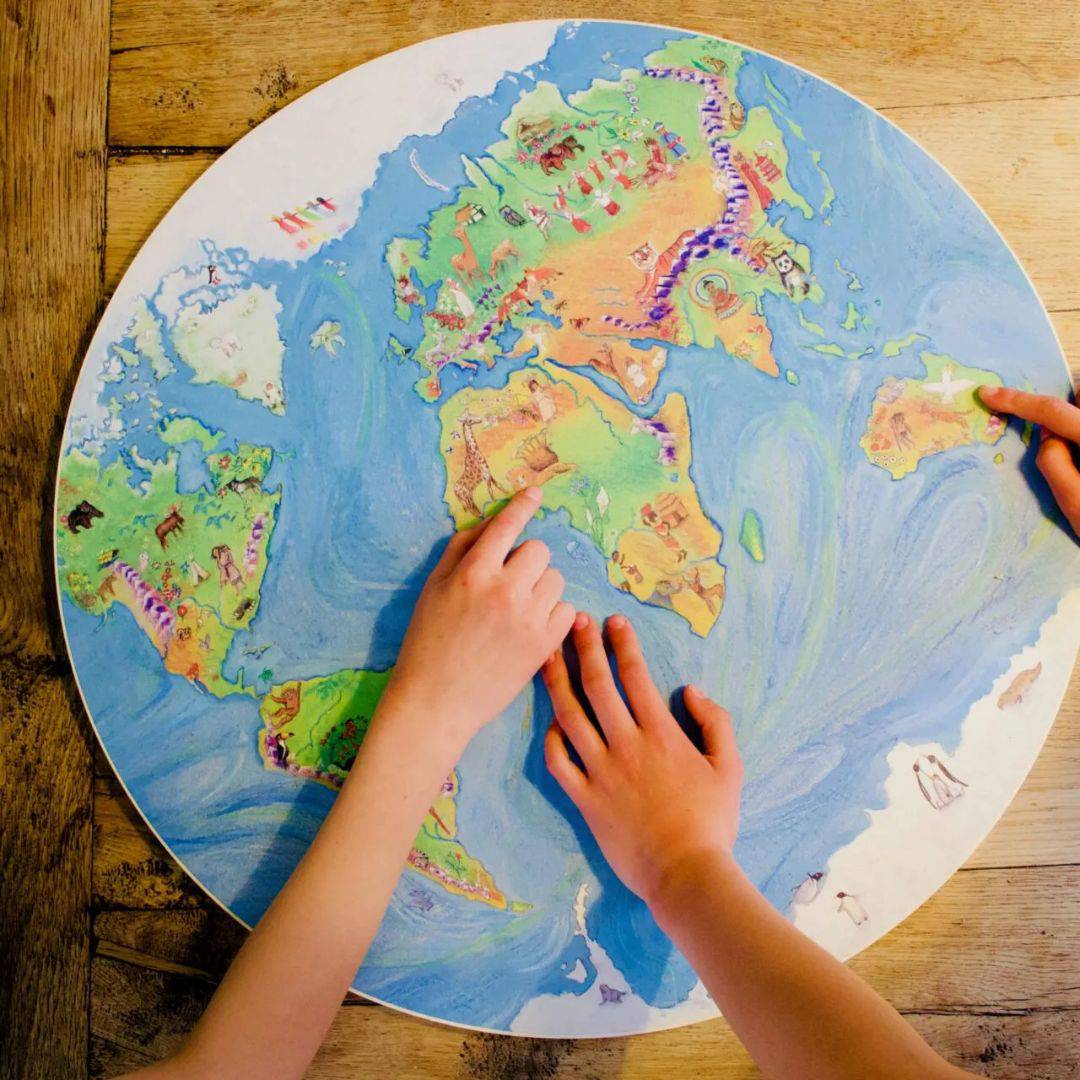 Waldorf Family- Child playing with world map- Bella Luna Toys
