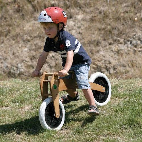 Child riding Wishbone bike outdoors